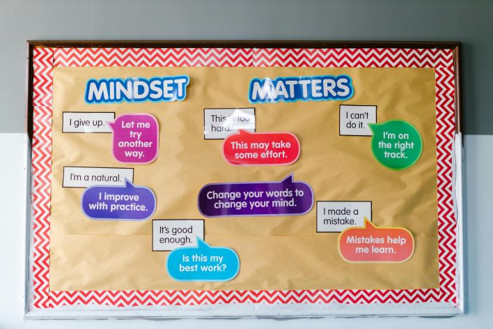 Colorful educational bulletin board with positive mindset messages for students.