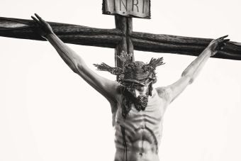 Monochrome depiction of Jesus crucified, showcasing religious artistry and sacrifice.