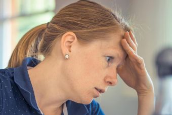 Businesswoman showing stress and concentration while working at her desk.