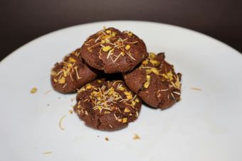 Mouthwatering chocolate cookies topped with nuts, perfect for a sweet treat.